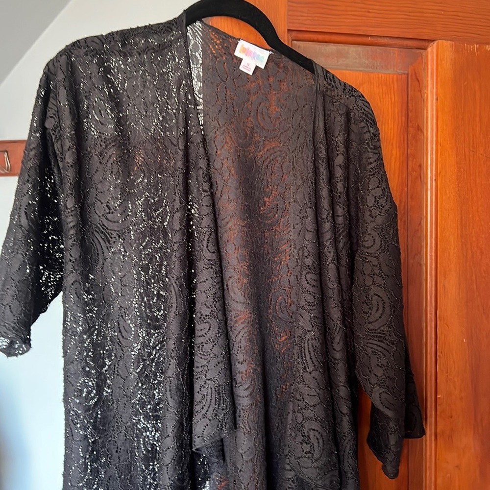 Long black short sleeve lace cardigan. Light not like a fully cover cardigan.